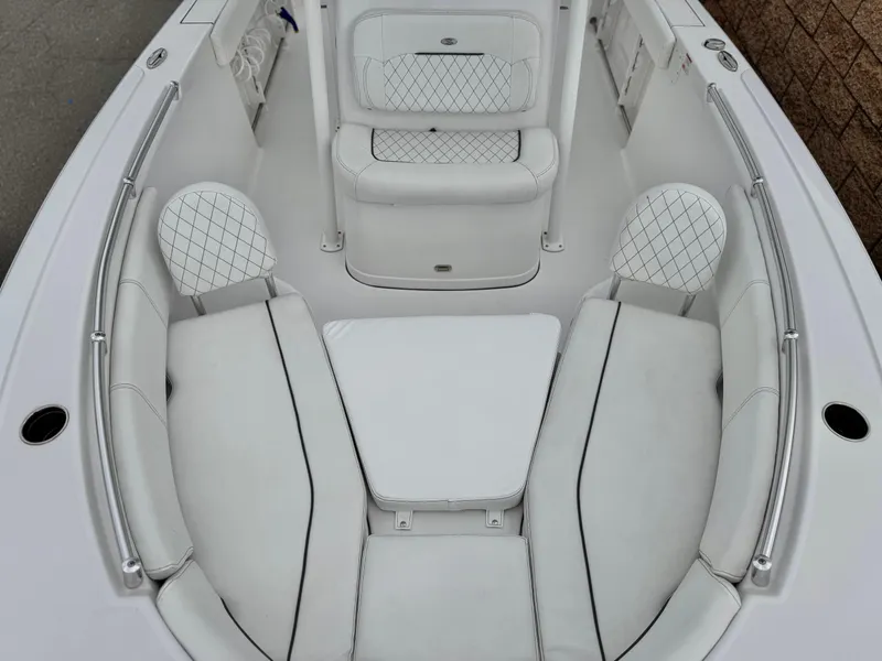 Slide: The Image of 2022 Sportsman Heritage 241 Center Console boat with white cushioned seating. - 10