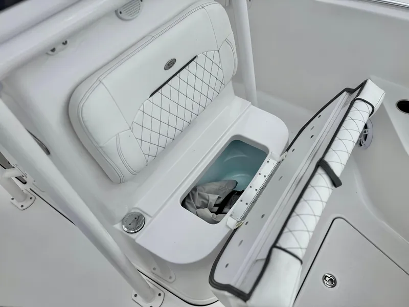 Slide: The Image of 2022 Sportsman Heritage 241 Center Console boat with open storage compartment and cushioned seating. - 14