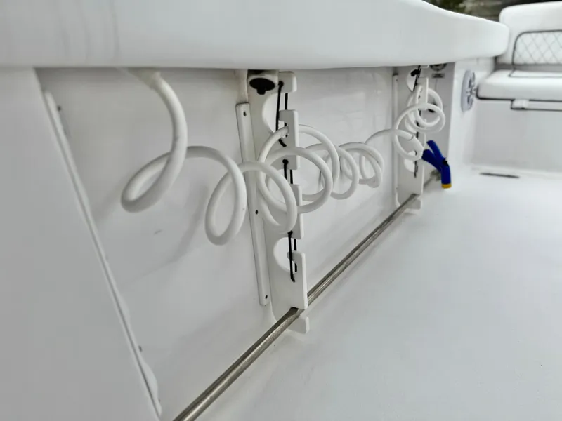 Slide: The Image of 2022 Sportsman Heritage 241 Center Console boat with coiled white cables and storage features. - 15