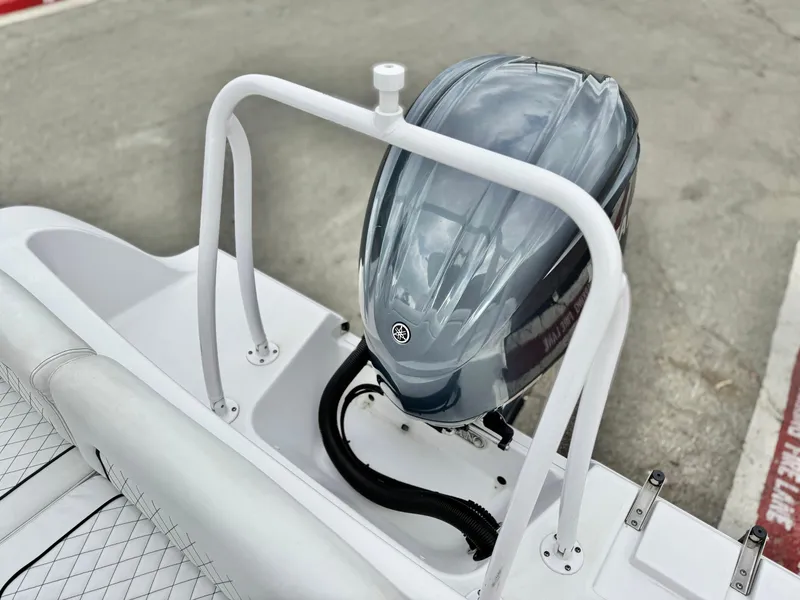 Slide: The Image of 2022 Sportsman Heritage 241 Center Console boat with sleek outboard motor design. - 19