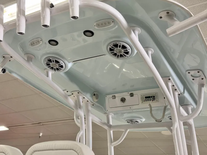 Slide: The Image of 2022 Sportsman Heritage 241 Center Console boat interior with speakers and rod holders. - 22