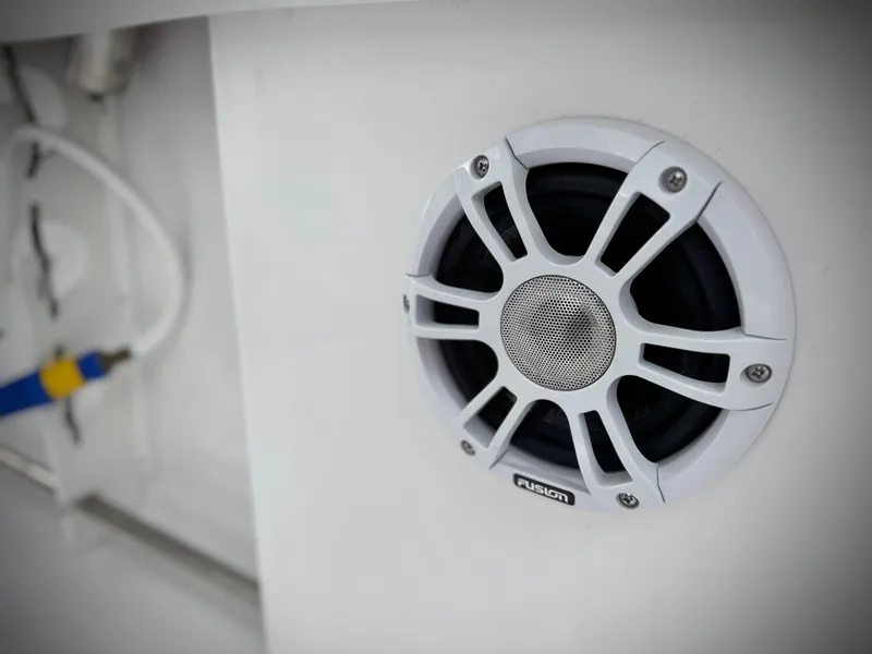 Slide: The Image of White Fusion speaker on 2022 Sportsman Heritage 241 Center Console boat. - 23