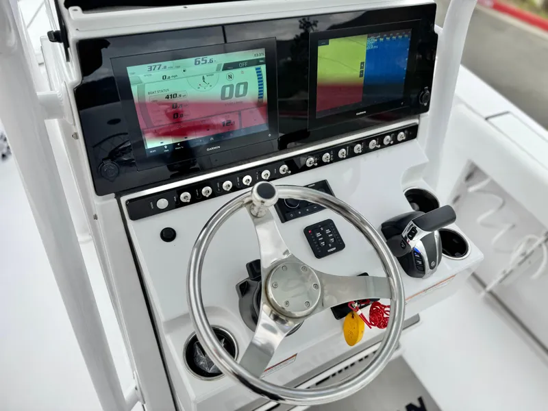 Slide: The Image of 2022 Sportsman Heritage 241 Center Console dashboard with steering wheel and digital displays. - 26