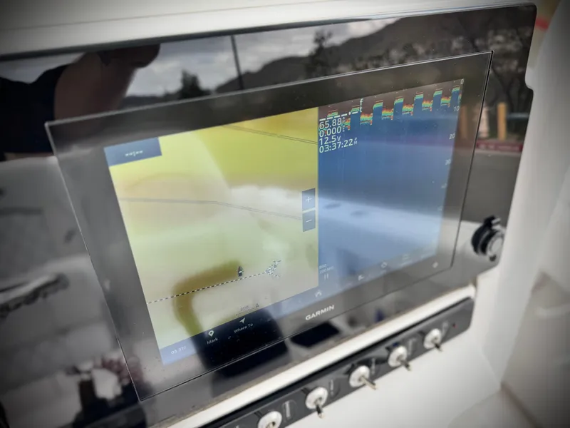 Slide: The Image of 2022 Sportsman Heritage 241 Center Console with Garmin navigation display. - 28