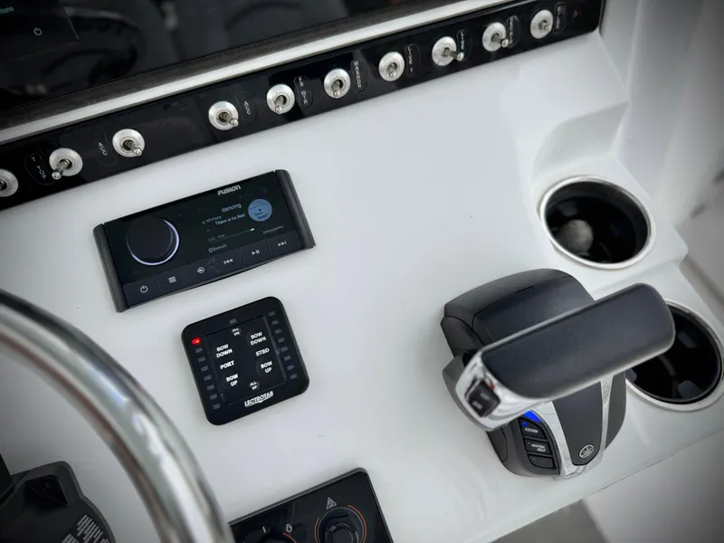 Slide: The Image of Center console controls of 2022 Sportsman Heritage 241 boat, featuring modern navigation and throttle systems. - 29