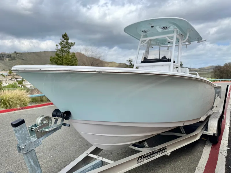 Slide: The Image of 2022 Sportsman Heritage 241 Center Console boat on trailer, parked outdoors. - 3