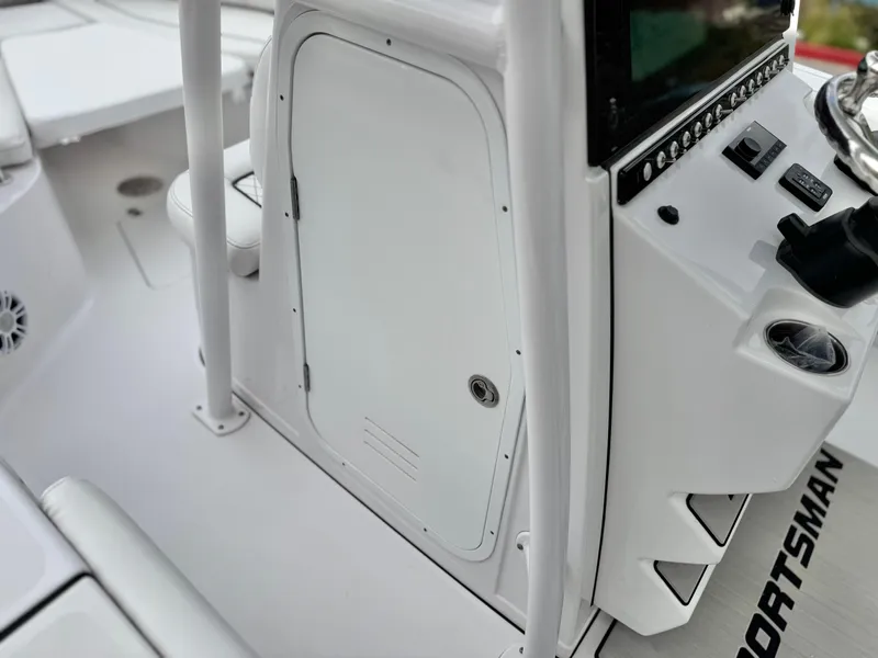 Slide: The Image of 2022 Sportsman Heritage 241 Center Console boat interior with control panel and storage compartment. - 30