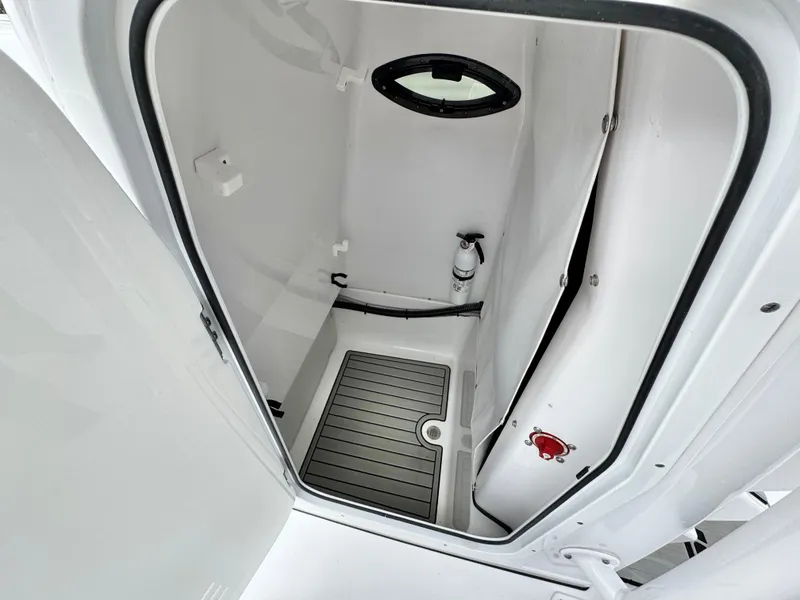 Slide: The Image of 2022 Sportsman Heritage 241 Center Console interior storage compartment with fire extinguisher. - 31