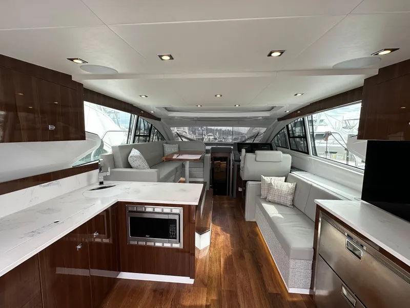 Slide: The Image of Luxurious interior of 2023 Cruisers Yachts 46 Cantius with modern kitchen and seating area. - 11