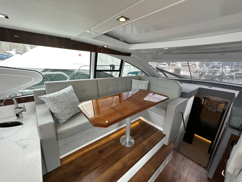 Slide: The Image of Luxurious interior of 2023 Cruisers Yachts 46 Cantius with elegant seating and wooden table. - 12