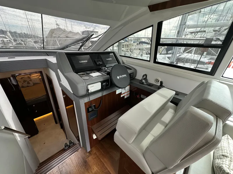 Slide: The Image of 2023 Cruisers Yachts 46 Cantius helm with modern controls and comfortable seating. - 13