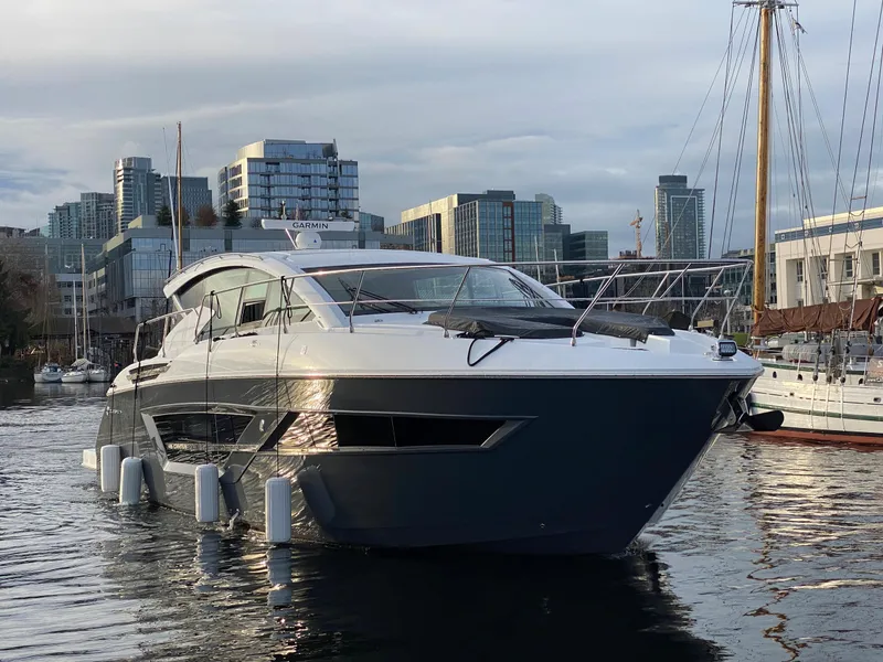 Slide: The Image of 2023 Cruisers Yachts 46 Cantius in urban marina setting. - 2