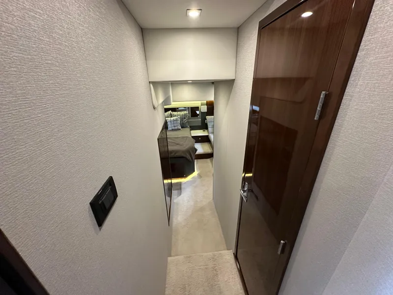 Slide: The Image of 2023 Cruisers Yachts 46 Cantius interior hallway leading to a luxurious bedroom. - 21