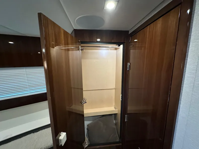 Slide: The Image of 2023 Cruisers Yachts 46 Cantius interior closet with wooden finish and open door. - 24