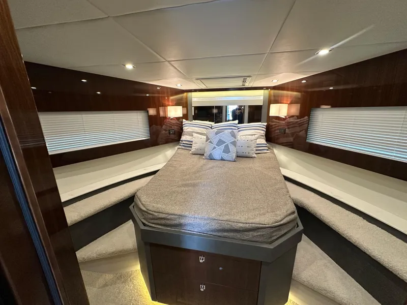 Slide: The Image of Luxurious interior of 2023 Cruisers Yachts 46 Cantius with elegant bedding and ambient lighting. - 26
