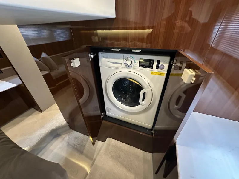 Slide: The Image of 2023 Cruisers Yachts 46 Cantius interior with built-in washing machine. - 27