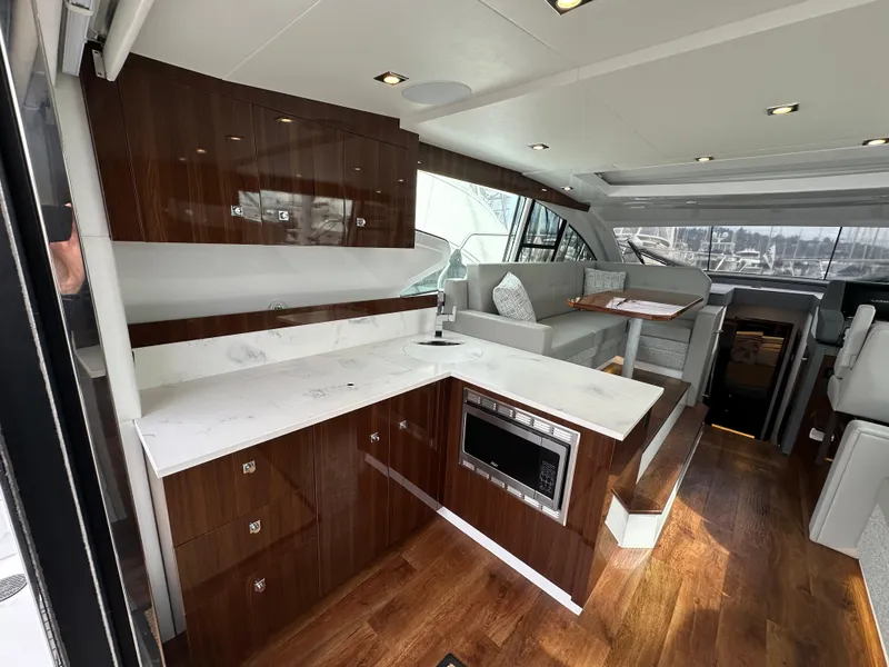Slide: The Image of Luxurious interior of 2023 Cruisers Yachts 46 Cantius with modern kitchen and seating area. - 37