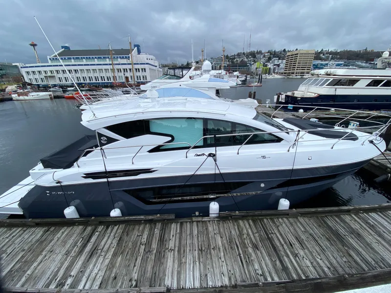Slide: The Image of 2023 Cruisers Yachts 46 Cantius docked at a marina, showcasing sleek design and modern features. - 4