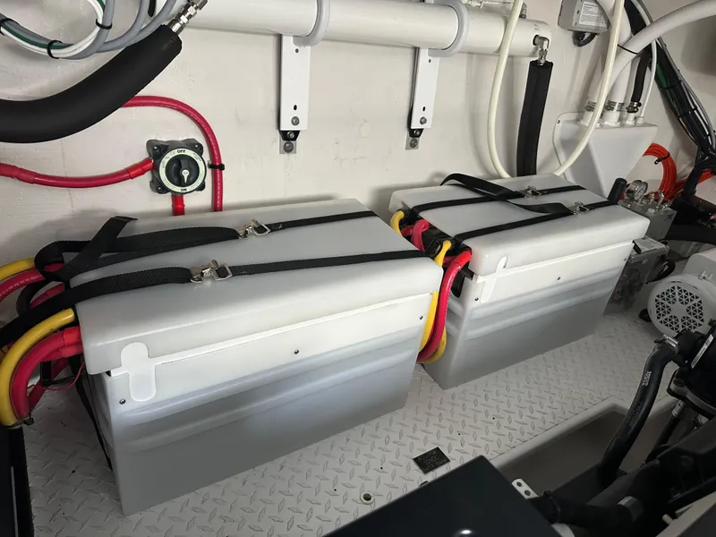 Slide: The Image of Battery compartment of 2023 Cruisers Yachts 46 Cantius, featuring dual secured batteries. - 43