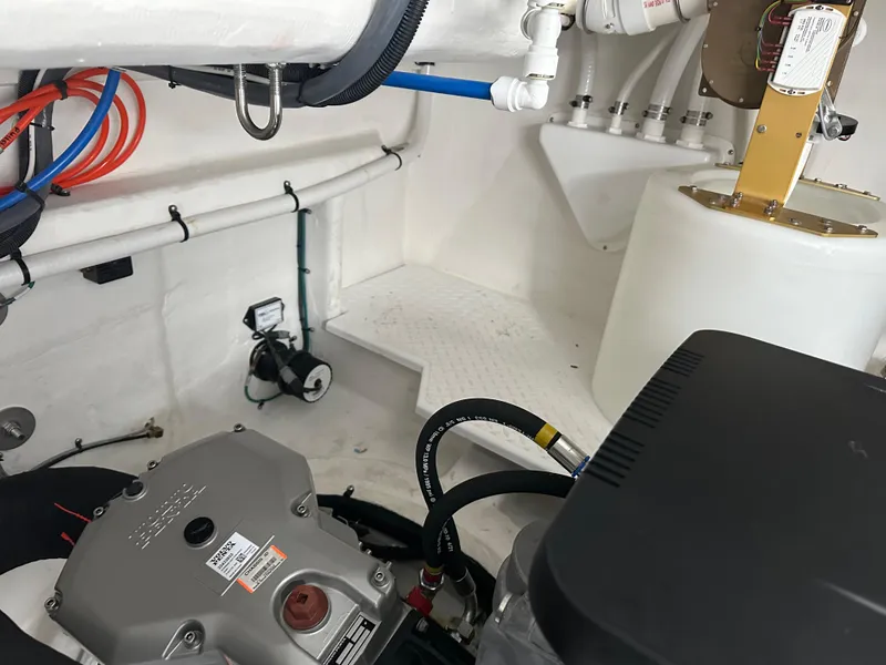 Slide: The Image of Engine room of 2023 Cruisers Yachts 46 Cantius, showcasing mechanical components and piping. - 46