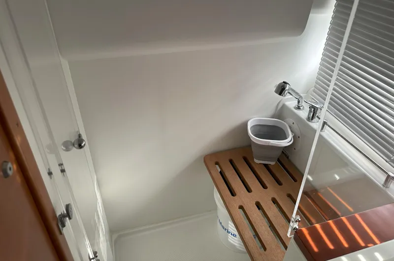 Slide: The Image of 2016 Jeanneau NC 11 bathroom with compact sink and wooden floor panel. - 16