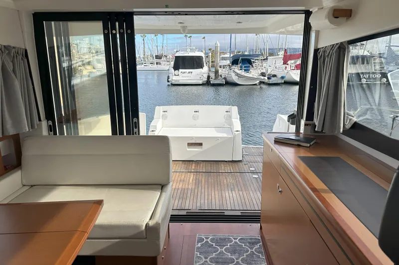 Slide: The Image of Interior view of 2016 Jeanneau NC 11 yacht with marina backdrop. - 17
