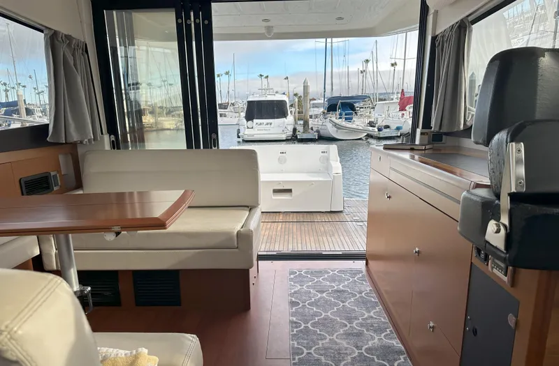 Slide: The Image of Interior of 2016 Jeanneau NC 11 yacht with marina view through open doors. - 21