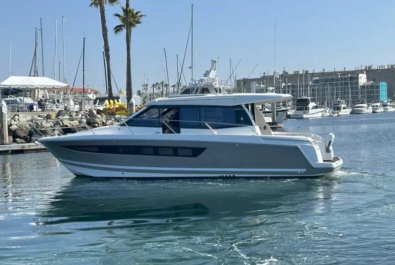 Slide: The Image of 2016 Jeanneau NC 11 yacht cruising in a marina with clear skies. - 4