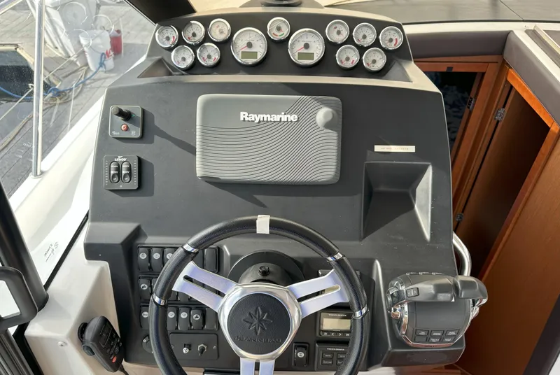 Slide: The Image of 2016 Jeanneau NC 11 helm with Raymarine navigation system and gauges. - 6