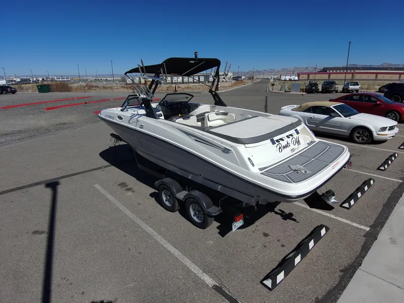 Slide: The Image of 2017 Bayliner VR6 boat on trailer in parking lot under clear blue sky. - 10
