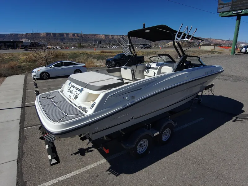 Slide: The Image of 2017 Bayliner VR6 boat on trailer in parking lot, sunny day, mountainous background. - 13