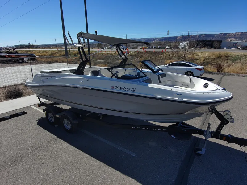 Slide: The Image of 2017 Bayliner VR6 boat on trailer in parking lot under clear blue sky. - 14