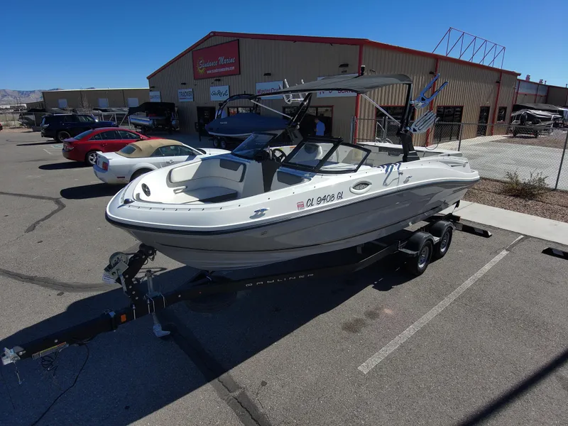 Slide: The Image of 2017 Bayliner VR6 boat on trailer in parking lot, near Sudweeks Marine building. - 3