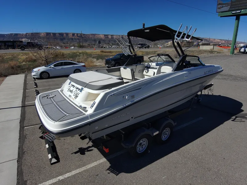 Slide: The Image of 2017 Bayliner VR6 boat on trailer in parking lot, sunny day, mountainous background. - 4