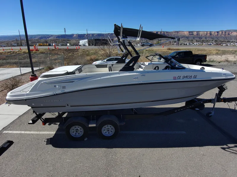 Slide: The Image of 2017 Bayliner VR6 boat on trailer, parked in a lot under clear blue sky. - 5