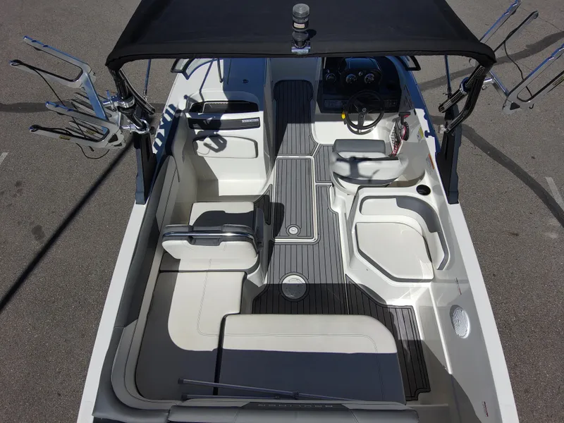 Slide: The Image of 2017 Bayliner VR6 boat interior with seating, steering wheel, and storage compartments. - 7