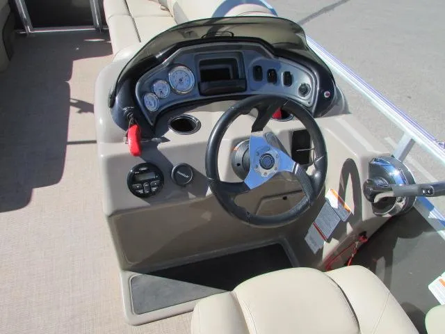 Slide: The Image of 2021 Sun Tracker Party Barge 20 DLX helm with steering wheel and control panel. - 11