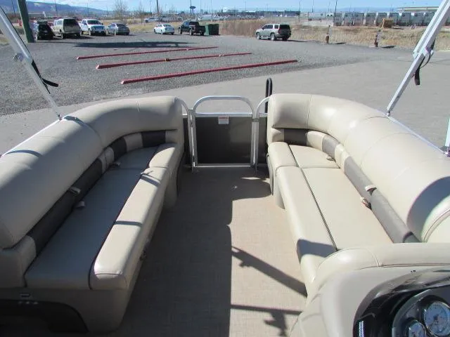 Slide: The Image of 2021 Sun Tracker Party Barge 20 DLX interior with beige seating and open deck layout. - 13