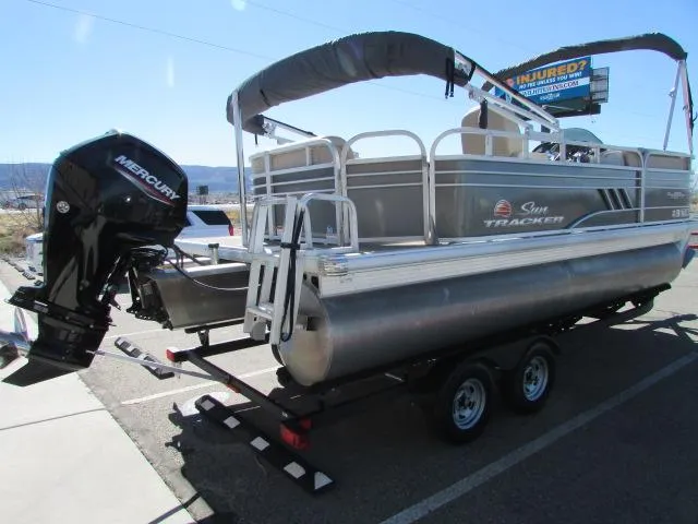 Slide: The Image of 2021 Sun Tracker Party Barge 20 DLX pontoon boat on trailer, featuring Mercury outboard motor. - 3