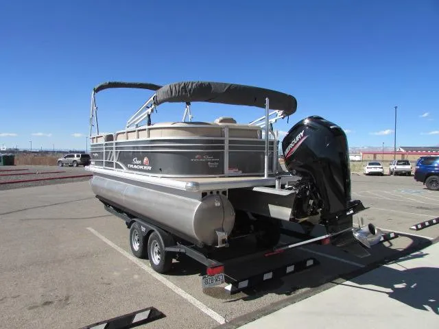 Slide: The Image of 2021 Sun Tracker Party Barge 20 DLX pontoon boat on trailer in parking lot. - 7