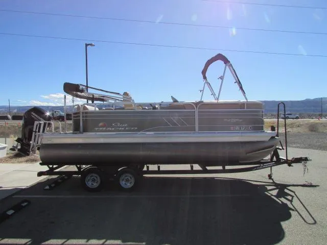 Slide: The Image of 2021 Sun Tracker Party Barge 20 DLX pontoon boat on trailer, parked outdoors. - 9