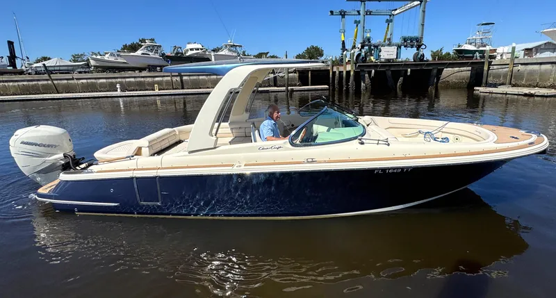Slide: The Image of 2023 Chris-Craft Launch 28 GT boat docked in marina, side view. - 1