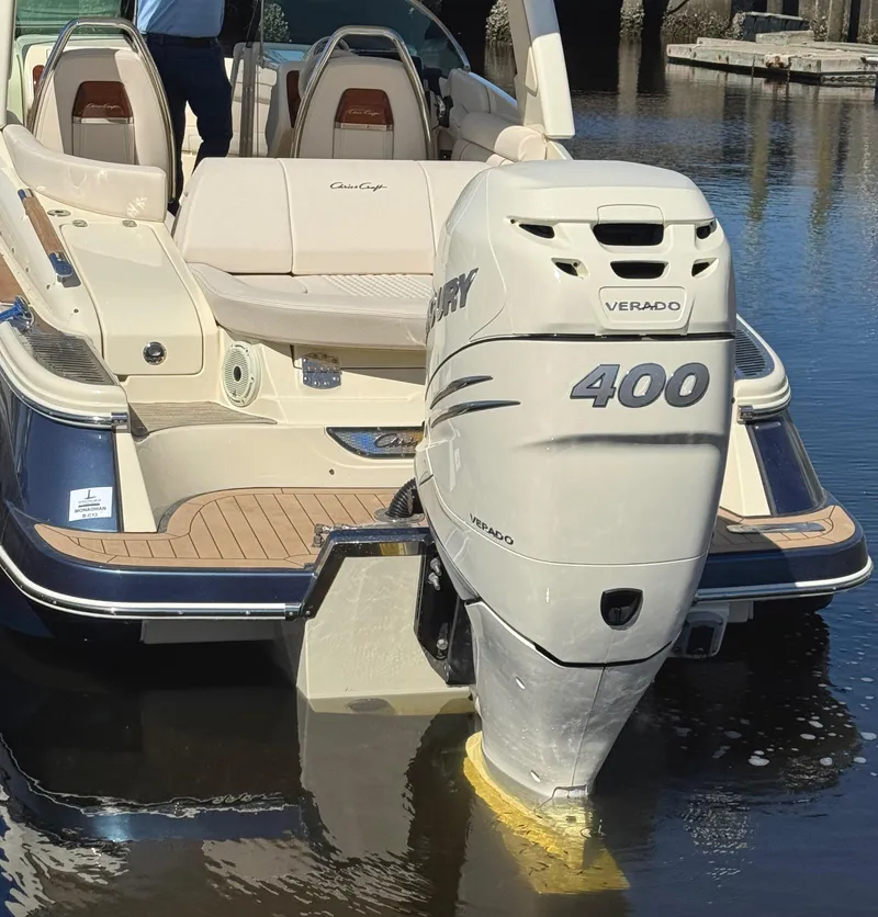 Slide: The Image of 2023 Chris-Craft Launch 28 GT with Mercury Verado 400 engine, docked on calm water. - 3