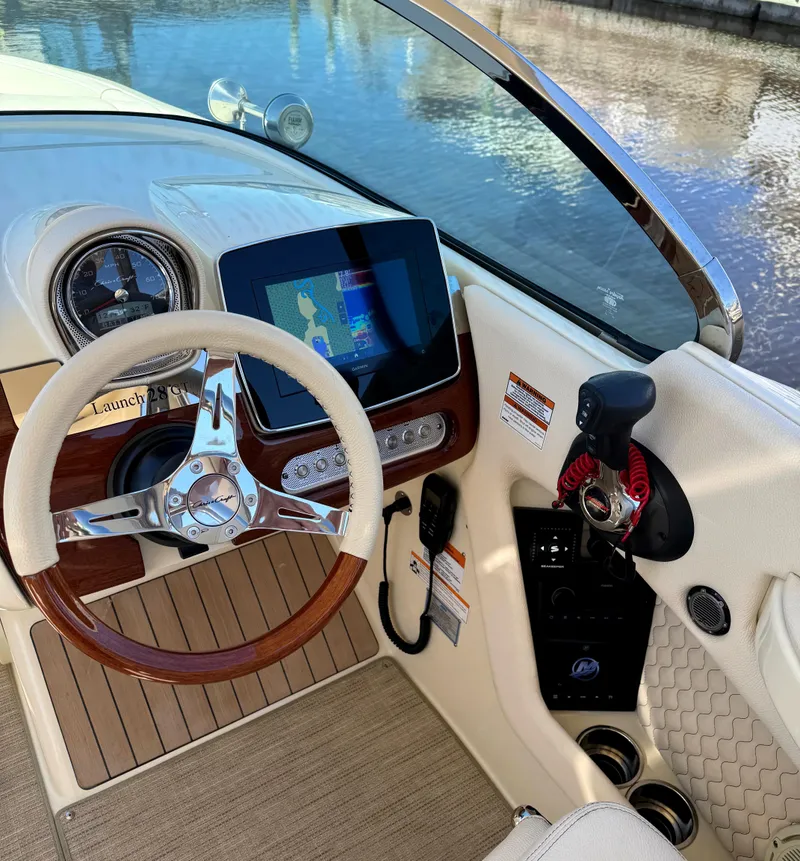 Slide: The Image of 2023 Chris-Craft Launch 28 GT dashboard with steering wheel and navigation display. - 4