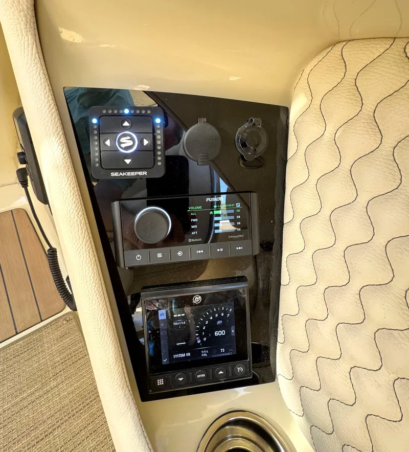 Slide: The Image of 2023 Chris-Craft Launch 28 GT dashboard with modern controls and beige upholstery. - 5