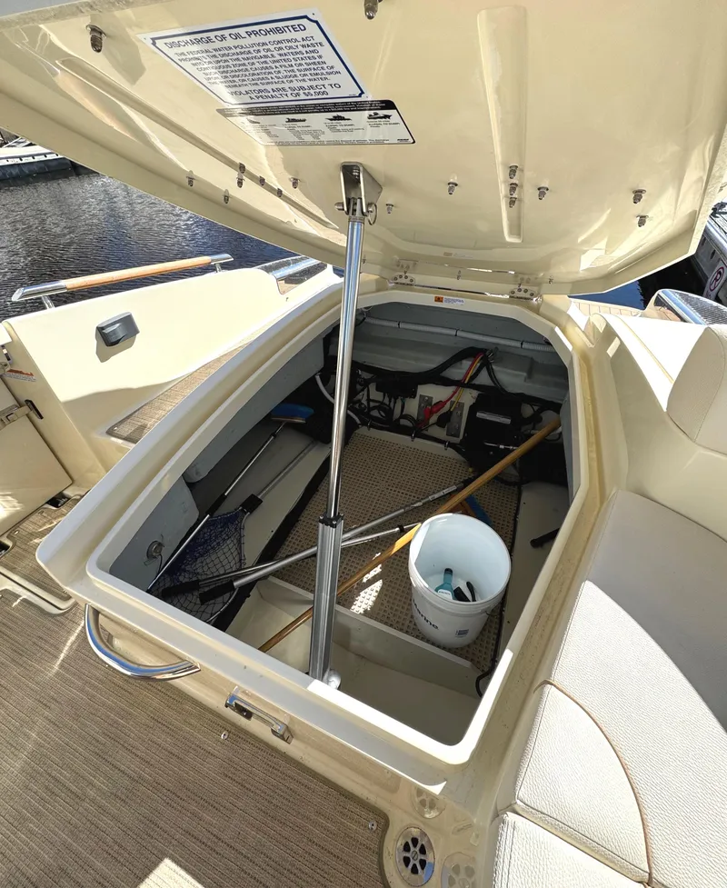 Slide: The Image of 2023 Chris-Craft Launch 28 GT storage compartment open, showcasing interior space and equipment. - 9