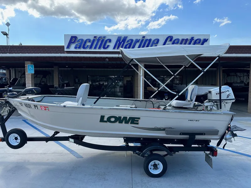 Slide: The Image of 2003 Lowe 1467 Sea Nymph boat on trailer at Pacific Marine Center. - 1