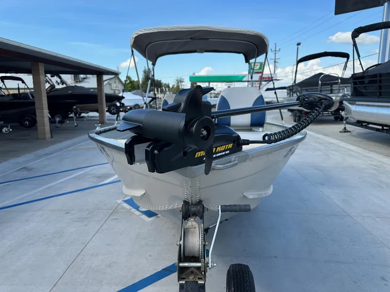 Slide: The Image of 2003 Lowe 1467 Sea Nymph boat with trolling motor, parked in a marina. - 10
