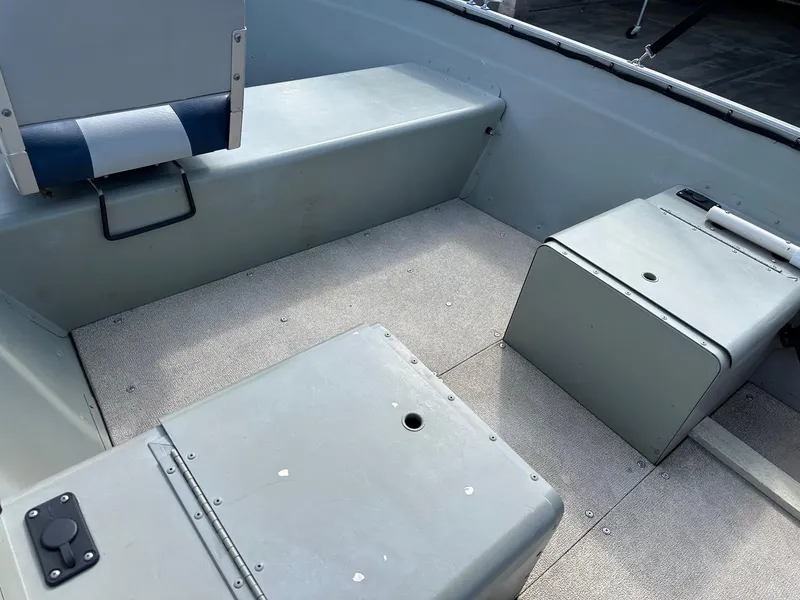 Slide: The Image of 2003 Lowe 1467 Sea Nymph boat interior with seating and storage compartments. - 12