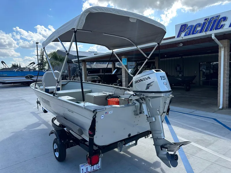 Slide: The Image of 2003 Lowe 1467 Sea Nymph boat with Honda motor, parked at Pacific dealership. - 6
